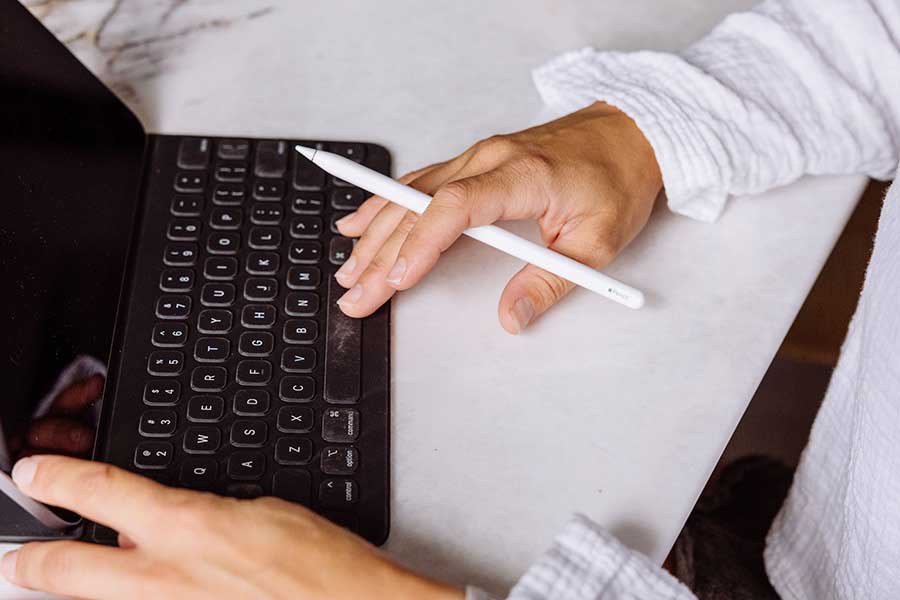 man typing on his ipad